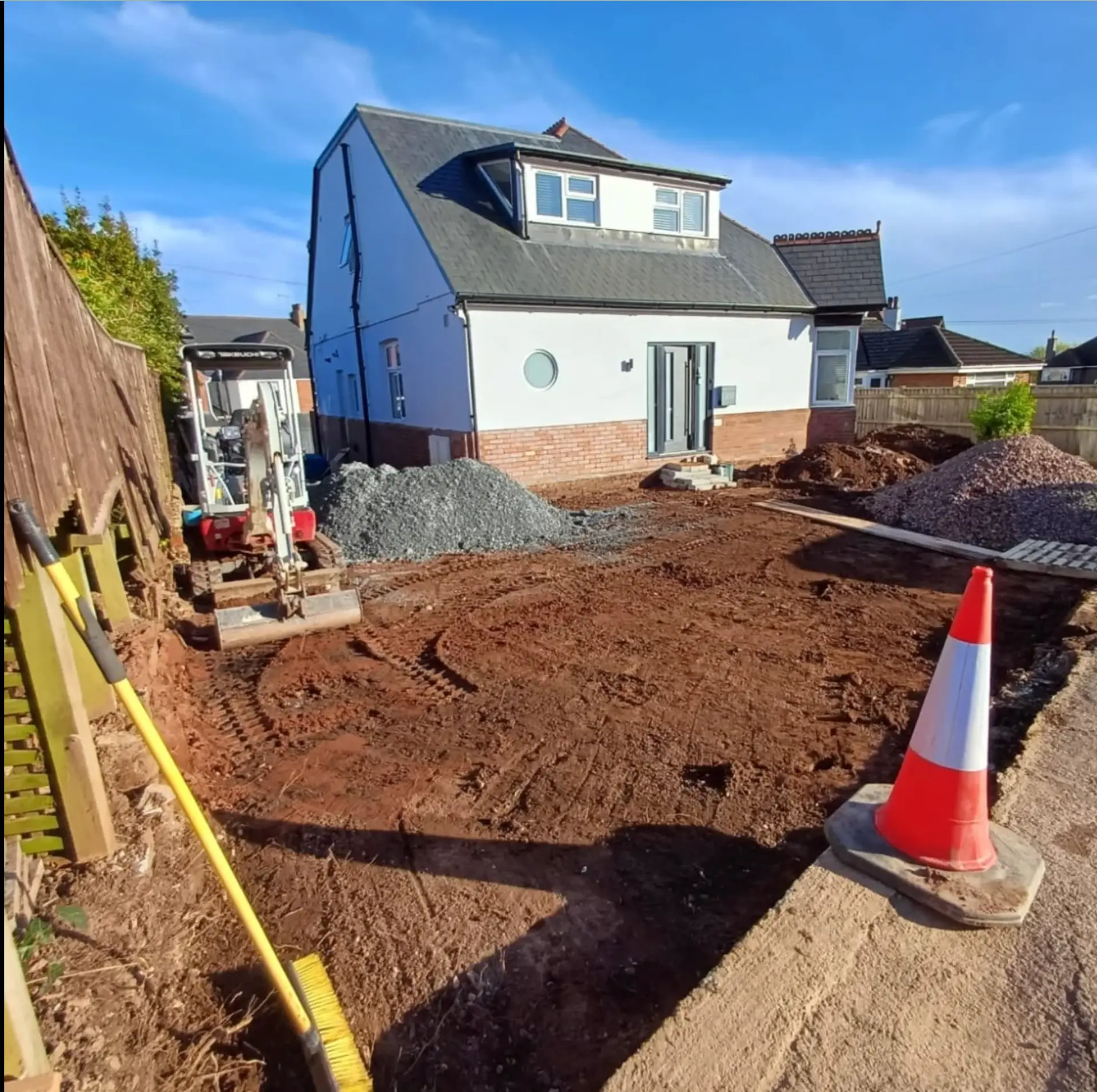 Step one — site excavated and stone brought in ready for the slab